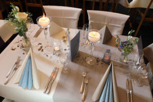 Ein eleganter Tisch mit einem weißen Tuch, das eine Atmosphäre von Raffinesse und Stil ausstrahlt.